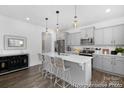 Modern kitchen featuring a central island with seating, stainless steel appliances, and stylish pendant lighting at 119 Stonewater Dr # 22, Red Cross, NC 28129