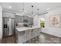 Modern kitchen featuring a central island with seating, stainless steel appliances, and stylish pendant lighting at 119 Stonewater Dr # 22, Red Cross, NC 28129
