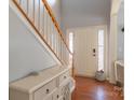 Inviting entryway with hardwood floors, decorative glass side panel, and stairway at 12112 Autumn Winds Ln, Pineville, NC 28134