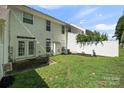 Back yard featuring a lush lawn, back patio, and mature landscaping at 140 N Arcadian Way, Mooresville, NC 28117