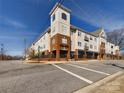 Attractive multi-story condo building with brick and siding exterior and well-maintained landscaping at 1410 4Th Street Nw Dr # 202, Hickory, NC 28601