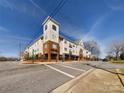 Attractive multi-story condo building with brick and siding exterior and well-maintained landscaping at 1410 4Th Street Nw Dr # 202, Hickory, NC 28601
