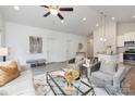 Open-concept living space with modern decor, including gray chairs, a stylish rug, and an adjacent kitchen area at 1511 W May Ave, Gastonia, NC 28052