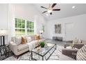Bright living room with a large window, neutral decor, comfortable seating, and a stylish glass coffee table at 1511 W May Ave, Gastonia, NC 28052