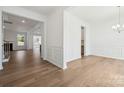 Bright foyer boasts hardwood floors, white trim, and an open concept living space at 15238 Ravenall Dr, Huntersville, NC 28078