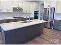 Modern kitchen boasts an island, stainless steel appliances, and stylish cabinetry at 15238 Ravenall Dr, Huntersville, NC 28078