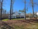 Inviting single-story home surrounded by lush trees, offering a serene and private setting at 1934 Hollybrook Ln, Lancaster, SC 29720
