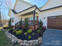 Charming front porch with swing, complemented by beautiful landscaping and a well-maintained exterior at 1934 Hollybrook Ln, Lancaster, SC 29720