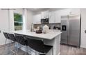 Modern kitchen features stainless steel appliances, a breakfast bar, and white cabinets at 208 Parker Claire Ln, Kings Mountain, NC 28086
