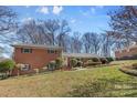 Lovely brick home with manicured shrubs and a charming, covered entrance at 211 Kingsway Cir, Charlotte, NC 28214