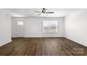 Bright living room with a ceiling fan, wood-look floors, and ample natural light at 230 Georgia Sw St # 63, Concord, NC 28025