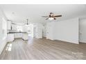 Open floor plan with kitchen island, modern lighting and neutral paint at 230 Georgia Sw St, Concord, NC 28025