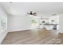Bright open-concept living space featuring modern floors, windows, and kitchen area at 230 Georgia Sw St, Concord, NC 28025