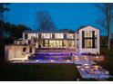 Beautiful backyard featuring an elegant pool, patio, and manicured lawn, perfect for outdoor living at 2536 Brawley School Rd, Mooresville, NC 28117
