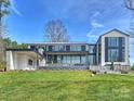 Expansive modern home with large windows and manicured lawn at 2536 Brawley School Rd, Mooresville, NC 28117