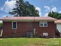 A sturdy brick home featuring a durable metal roof and a well-maintained lawn at 3101 Harvell St, Gastonia, NC 28052