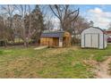 Exterior view of two sheds with metal roofs, wooden walls, and a backyard setting, providing practical storage solutions at 3101 Harvell St, Gastonia, NC 28052