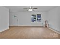 Bright and airy living room with neutral paint, wood-look flooring, ceiling fan, and natural light at 425 Messner St, Salisbury, NC 28144