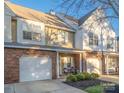 Charming townhome featuring a brick facade, single-car garage, manicured front yard, and inviting entrance at 4507 Antelope Ln, Charlotte, NC 28269
