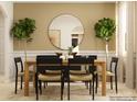 Dining room with a round mirror, plants, a wooden table, and seating for six at 4641 Potters Wheel Ct, Fort Mill, SC 29715