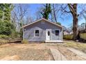 Exterior shot of gray home featuring updated siding, front entrance, and a neatly kept landscape at 4924 Jane Ave, Charlotte, NC 28269