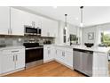 Modern kitchen featuring stainless appliances, stone countertops, and ample white cabinetry at 5404 Maplewood Ln, Charlotte, NC 28227