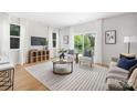 Bright living room featuring a stylish rug, neutral furniture, and sliding glass doors to bring the outdoors in at 5404 Maplewood Ln, Charlotte, NC 28227