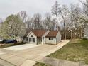 Charming home with a well-manicured lawn, mature trees, and a concrete driveway at 5610 Stone Bluff Ct, Charlotte, NC 28214