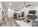 Inviting living room with hardwood floors and open access to a stylish kitchen area at 6321 Rockwell W Blvd, Charlotte, NC 28269