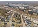 Aerial view of the property showcasing the surrounding neighborhood and city landscape with many buildings and houses at 701 S Torrence St, Charlotte, NC 28204