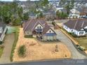 Expansive property displaying a well-maintained lawn, circular driveway, and mature trees surrounding the home at 894 Abilene Ln, Fort Mill, SC 29715