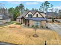 Beautifully landscaped home showcasing a brick exterior, covered porch, and a spacious front yard with mature trees at 894 Abilene Ln, Fort Mill, SC 29715