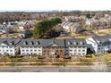 Aerial view of condo complex with manicured landscaping, trees, and parking areas, showcasing community layout at 1068 Plaza Walk Dr, Charlotte, NC 28215