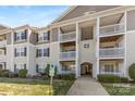 Multi-story condo building featuring private balconies, well-kept grounds and accessible parking at 1068 Plaza Walk Dr, Charlotte, NC 28215