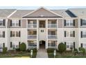 Close up on a multi-story condo building featuring private balconies, well-kept grounds and accessible parking at 1068 Plaza Walk Dr, Charlotte, NC 28215