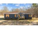Charming single-story home with blue siding, wooden shutters, front porch, and a well-maintained lawn at 1254 Raxter Rd, Edgemoor, SC 29712