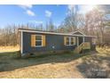 Charming single-story home with blue siding, wooden shutters, front porch, and a well-maintained lawn at 1254 Raxter Rd, Edgemoor, SC 29712