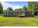 Charming home with blue siding, brick foundation and a lovely wooden porch at 1254 Raxter Rd, Edgemoor, SC 29712