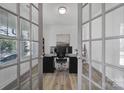 A well-lit office featuring french doors, neutral walls, modern decor, and a workspace with dual monitors at 16709 Mckee Rd, Charlotte, NC 28278