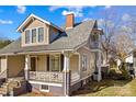 Side view of a home featuring a front porch, second-story balcony, and fresh exterior paint at 214 Maupin Ave, Salisbury, NC 28144