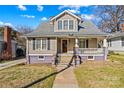Inviting two-story home with gray shingles, complementary colors, and a cozy front porch at 214 Maupin Ave, Salisbury, NC 28144