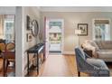 Inviting foyer with hardwood floors, black console table, and a view through the red front door at 253 Misenheimer Nw Dr, Concord, NC 28025