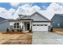 New construction single-Gathering home with stone accents, covered entryway, and attached two car garage at 3009 Bent Willow Dr # 160, Indian Trail, NC 28079