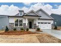 New construction single-Gathering home with stone accents, covered entryway, and attached two car garage at 3009 Bent Willow Dr # 160, Indian Trail, NC 28079