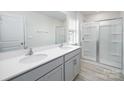 Bathroom features a double sink vanity, modern finishes, and a glass-enclosed shower at 327 Brinkley Dr # 107, Kings Mountain, NC 28086