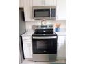 Close up of the stainless steel stove and microwave in the kitchen at 3240 Heathstead Pl, Charlotte, NC 28210