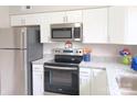 Modern kitchen with stainless steel appliances and white cabinets offers an efficient workspace at 3240 Heathstead Pl, Charlotte, NC 28210