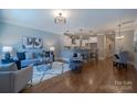 Open concept living room with hardwood floors, stylish furniture, and an open view to the kitchen at 435 Beacon Nw St, Concord, NC 28027
