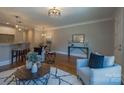 Well-lit living room featuring an open eat-in kitchen, hardwood floors, and neutral decor at 435 Beacon Nw St, Concord, NC 28027