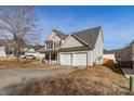 Home featuring a two-car garage, traditional siding, and a well-manicured lawn at 5023 Wicklow Dr, Gastonia, NC 28054